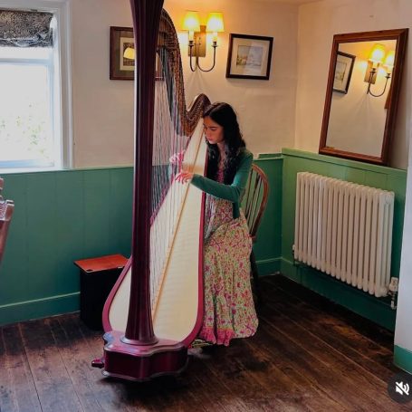 Lady Playing Harp at The Sorrel Horse Inn at Shottisham, Suffolk